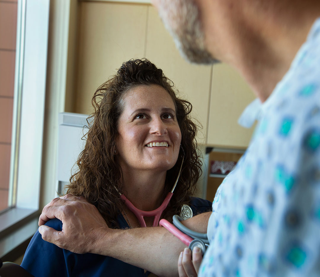 Nurse administering a BP Test