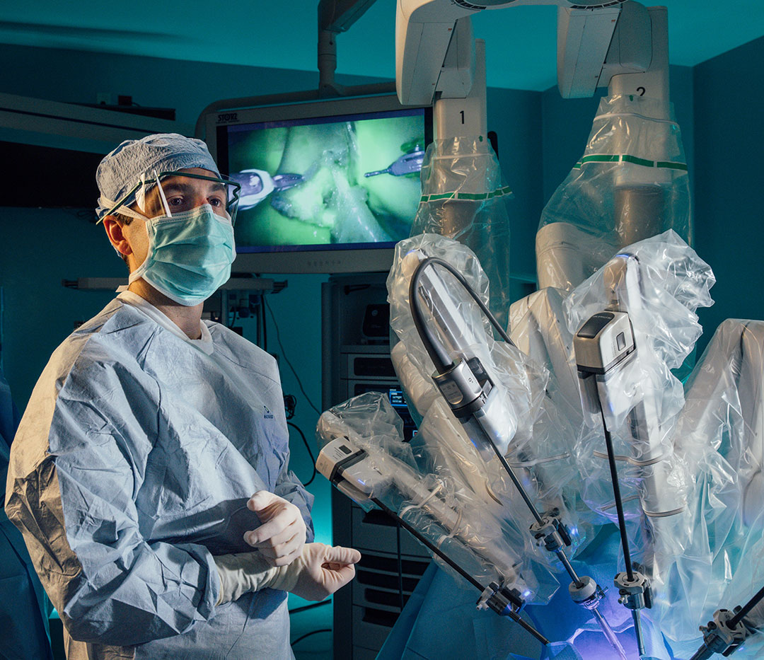 Doctor setting up robot for surgery