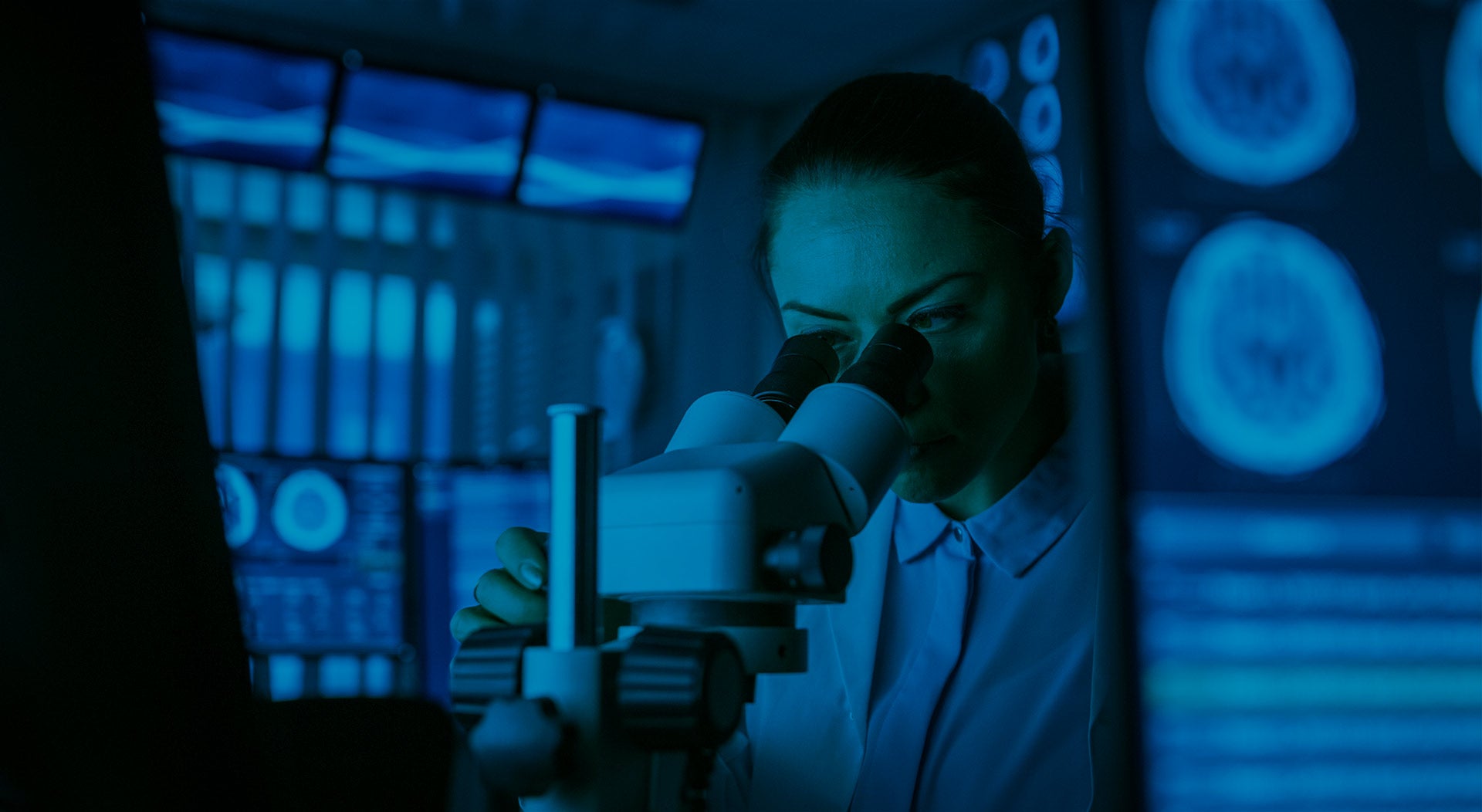 Clinical researcher looking in a microscope.