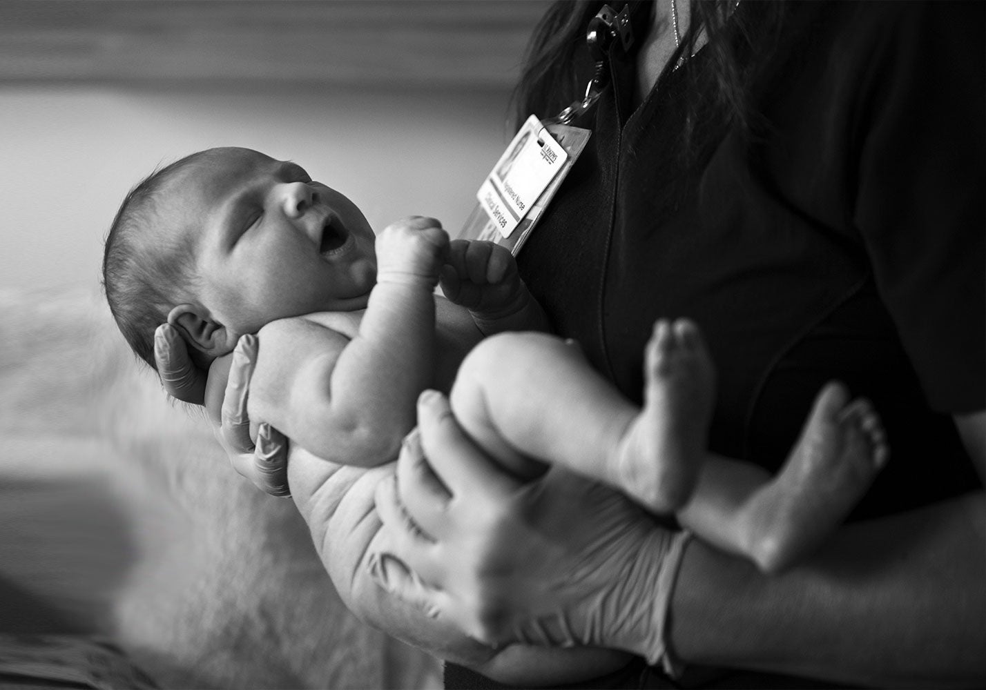 Provider holding a newborn baby.